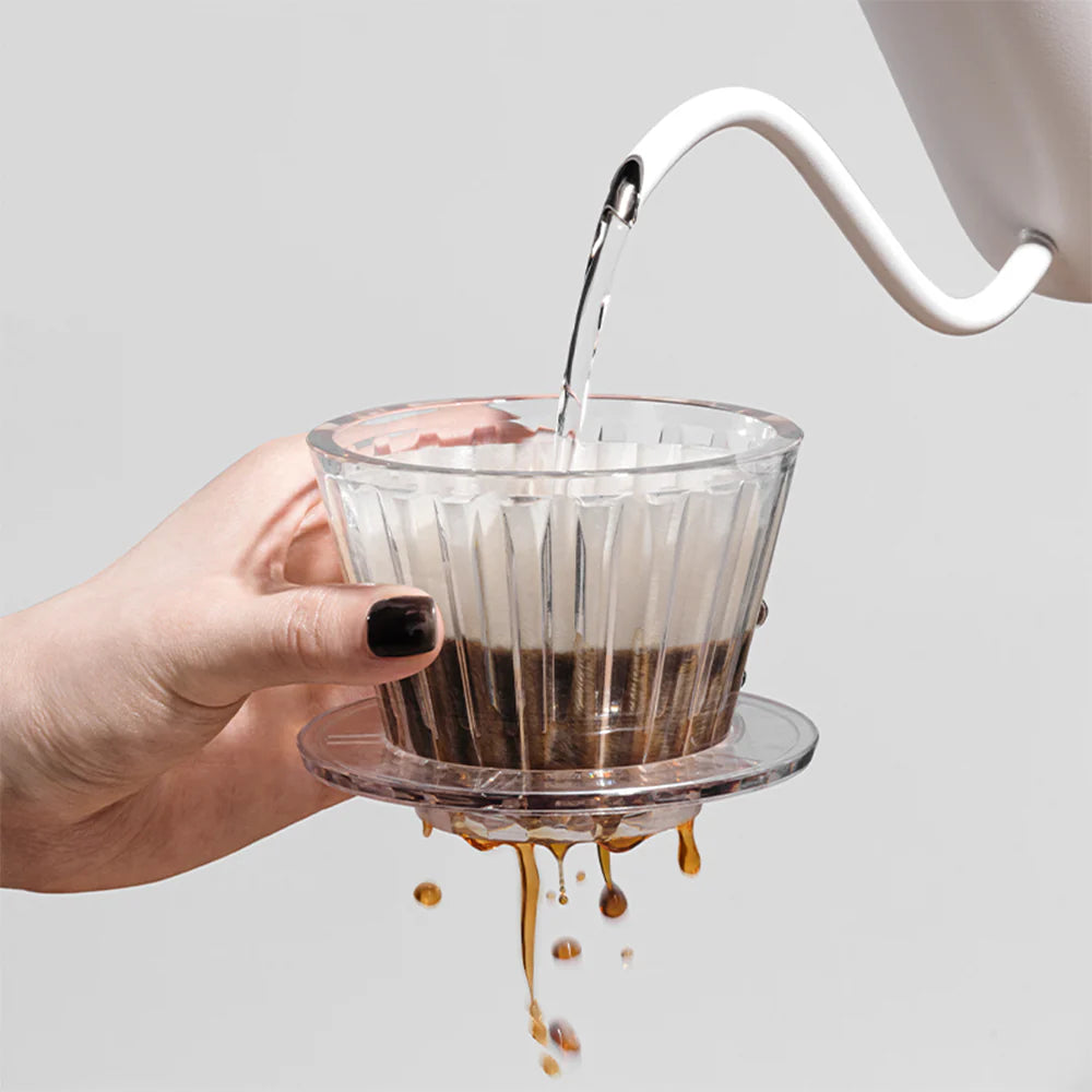 Water being poured into a filter basket with the filter paper. 