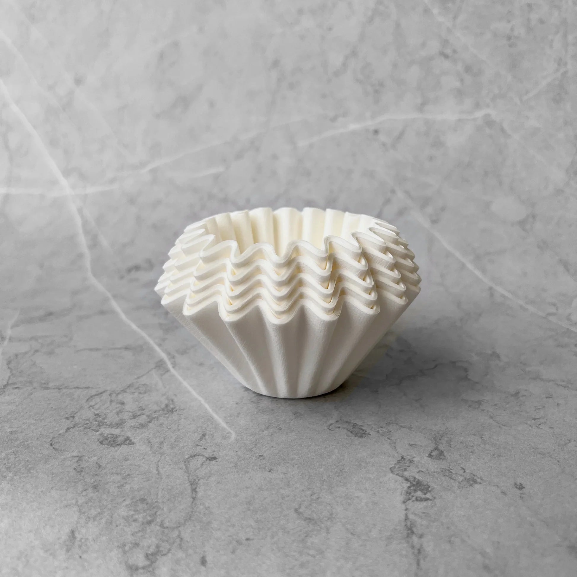 A set of 50 filter papers on a marble surface