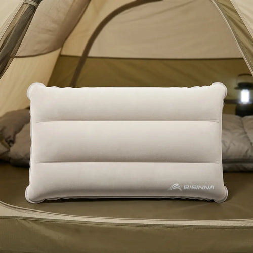 BISINNA CL005 Inflatable pillow on a camping mattress with a tent in the background.