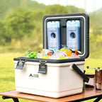 A shot of a BISINNA Cooler Box opened on top of a table featuring an outdoor background.