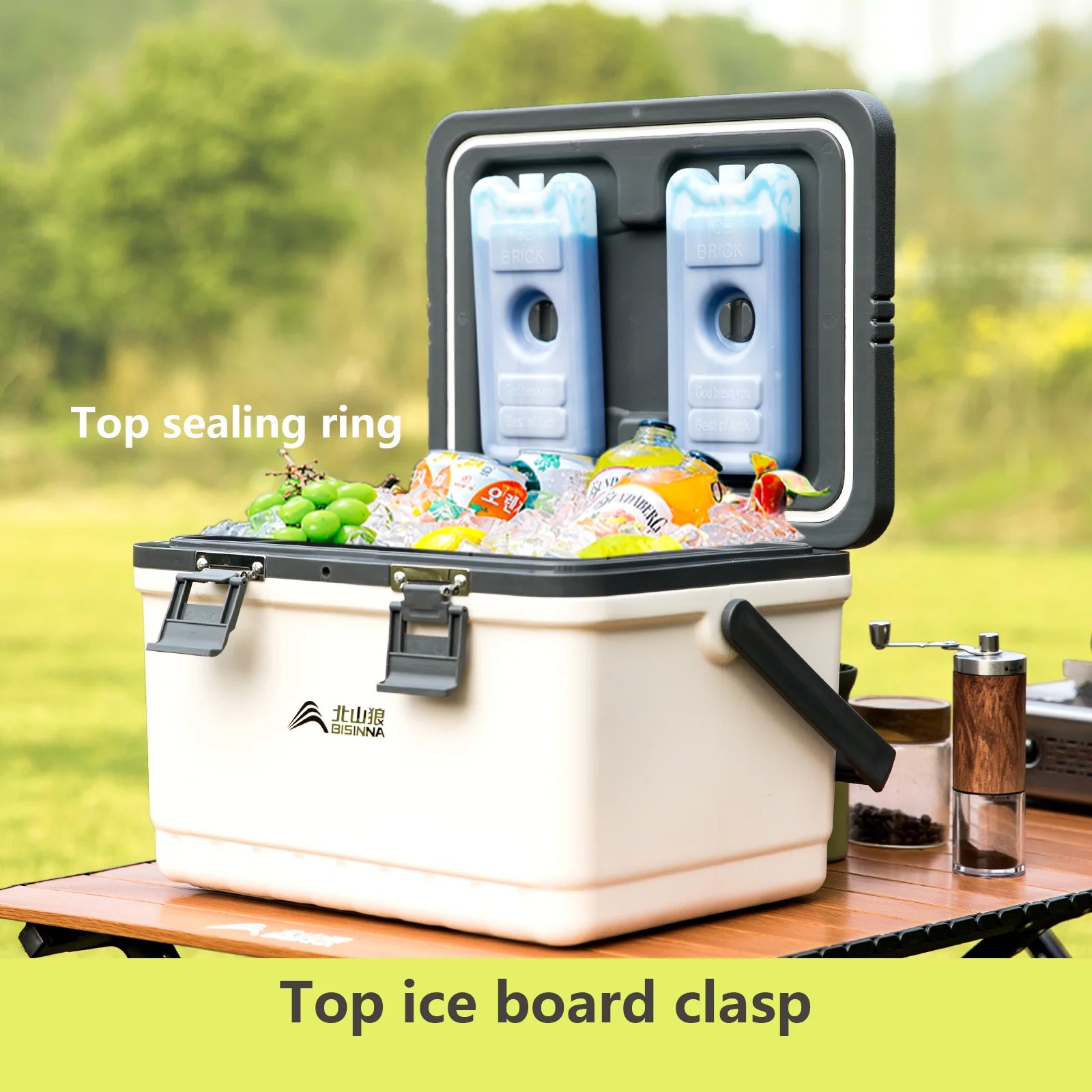 BISINNA White cooler box with ice cubes and food items on a table outdoors, featuring text labels on sealing ring and ice board clasp.