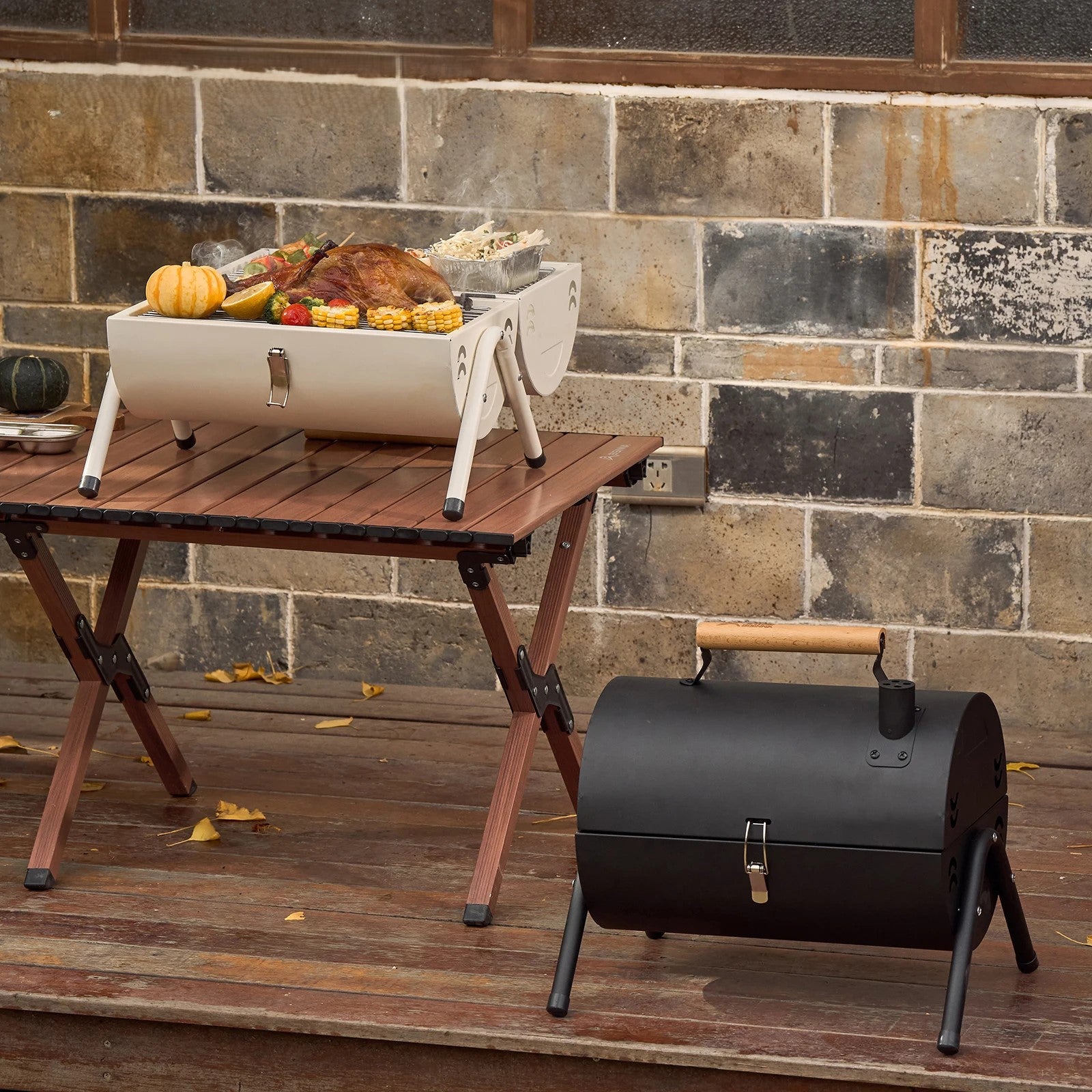 Portable BISINNA grills on a wooden table with a brick wall background