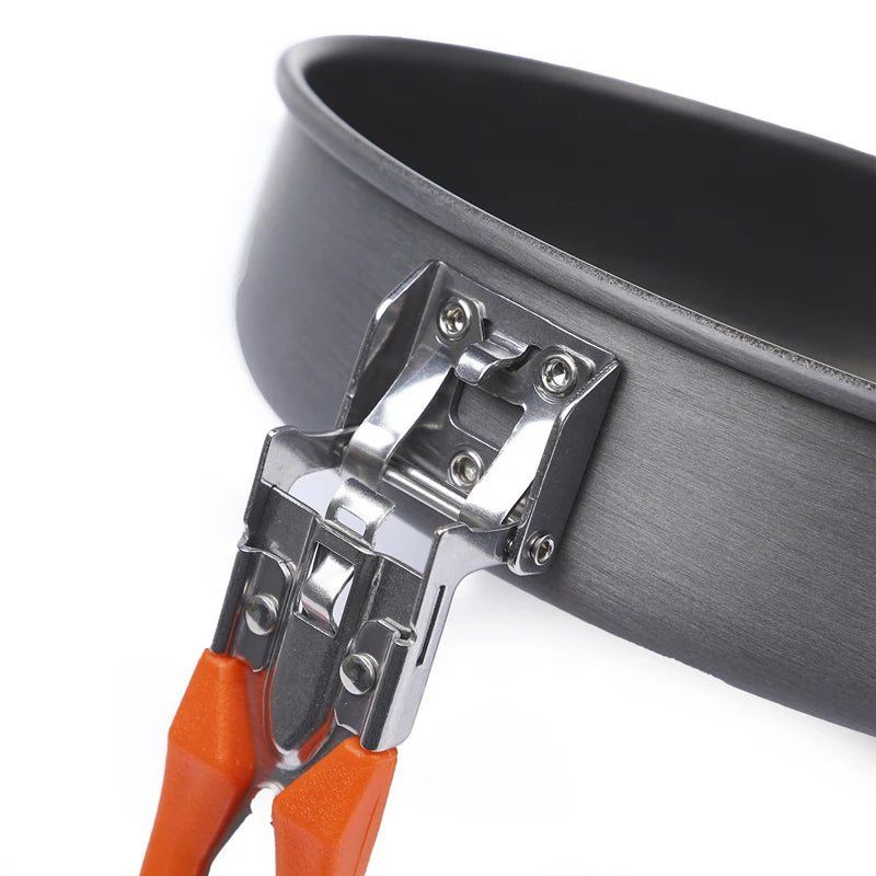 Close-up of a gray camping pot with orange handles on a white background