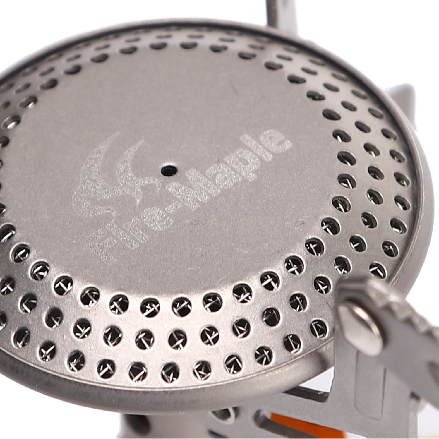 Close-up of a metal stove top with Fire Maple branding on a white background
