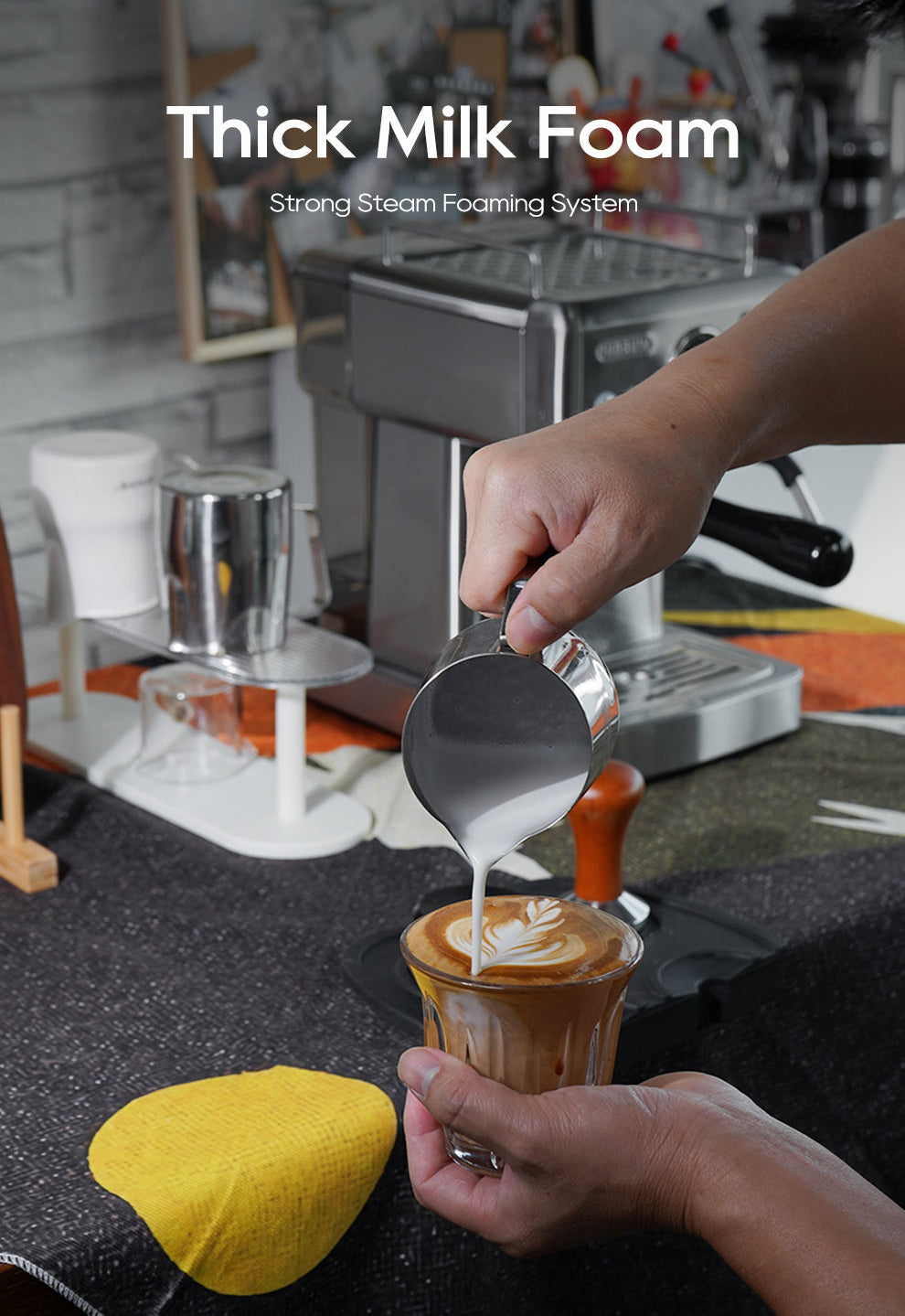 Person pouring thick milk foam into a coffee cup with a H10A espresso machine in the background.