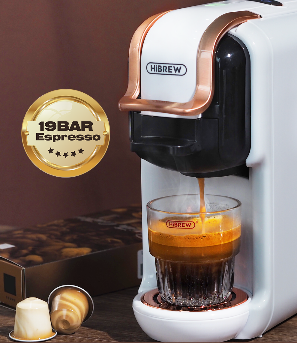 Hibrew H2B espresso machine dispensing coffee into a glass with a 19 bar espresso badge on a brown background.