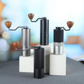 Set of four Havmore manual coffee grinders on a blurred background studio shot