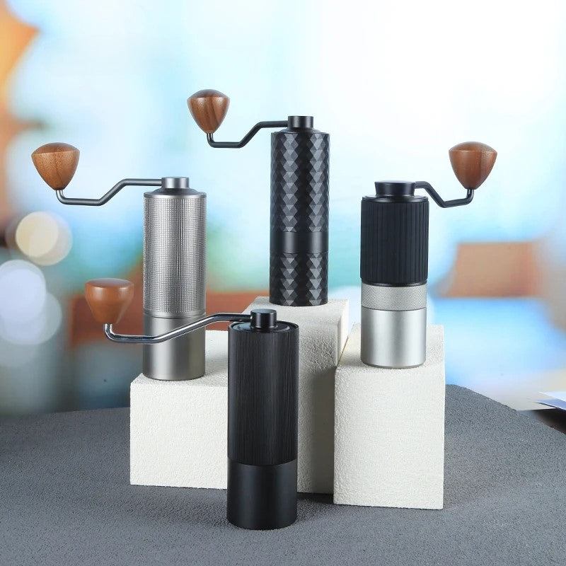 Set of four Havmore manual coffee grinders on a blurred background studio shot