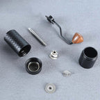 Disassembled G2 coffee grinder on a gray surface