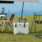 25L Mobi Cooler box with drinks on a grassy outdoor setting with camping gear.