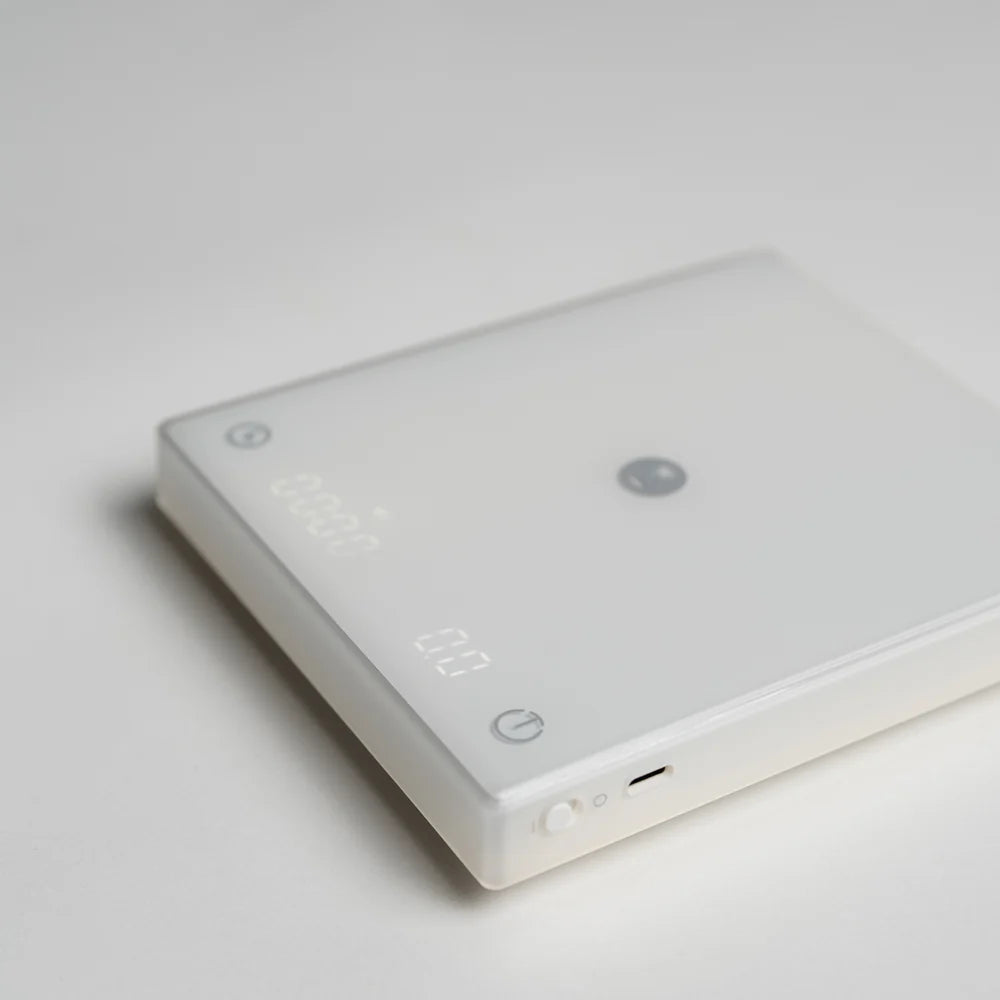 Close up shot of a TIMEMORE Black Mirror Pro coffee scale with a camera focus towards the corner 