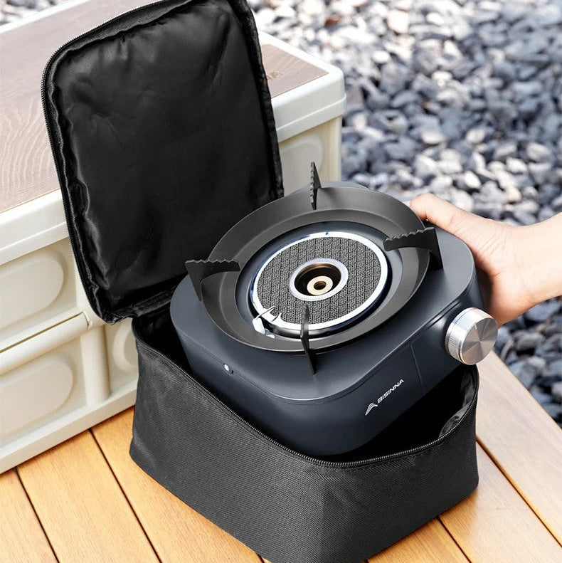 Portable SK256 gas stove with a black carrying case on a wooden surface.