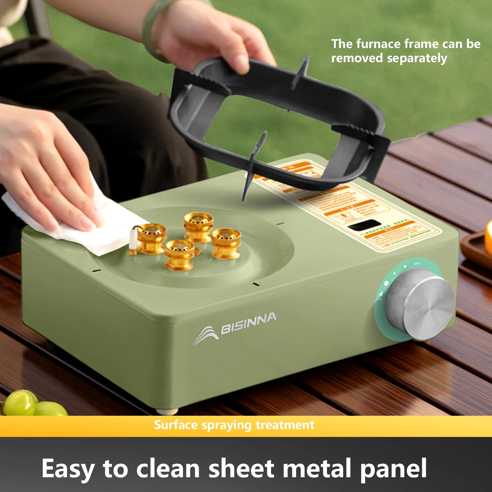 BISINNA SK218 Green camping stove with a person cleaning it, on a wooden surface with a green background.