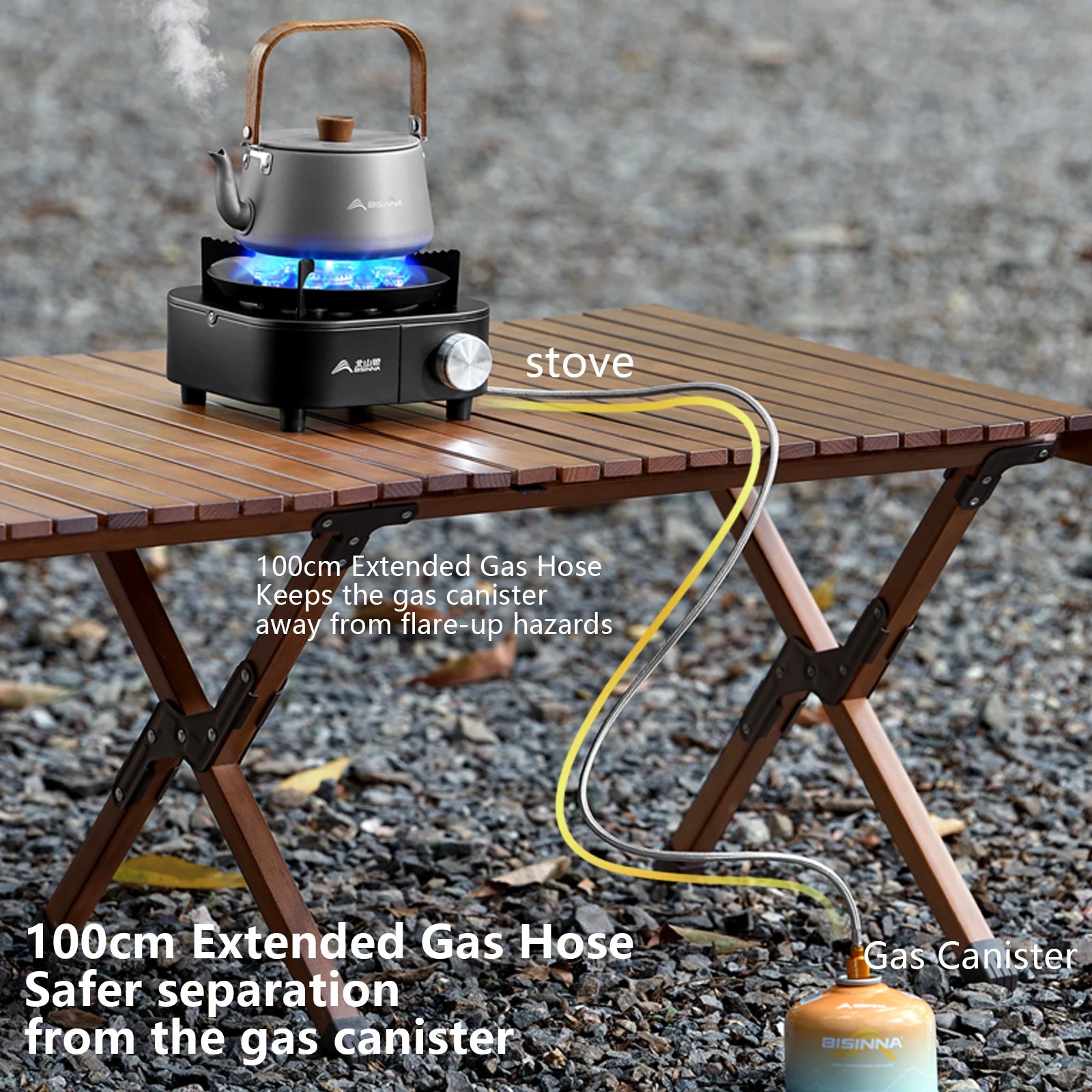 SK275 Portable stove with gas canister and extended hose on a wooden table outdoors.