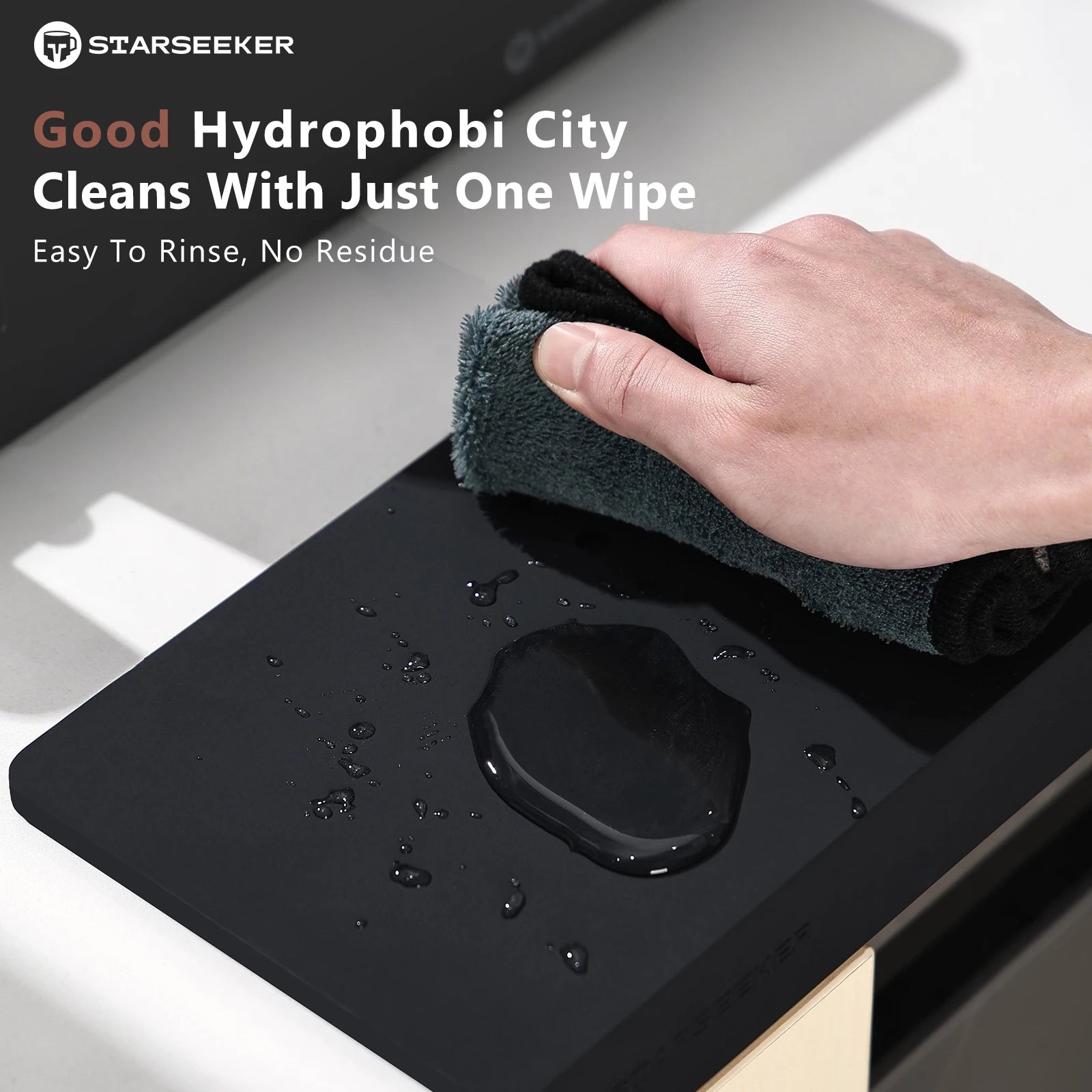Hand using a cloth to clean a black surface with text about hydrophobic city cleaning.