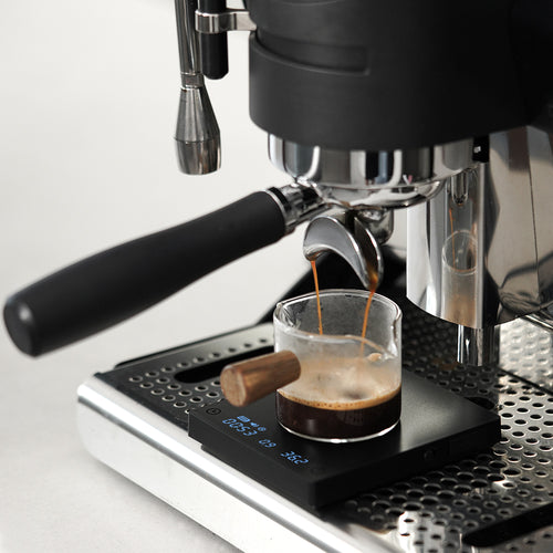 Timemore Black Mirror Basic Mini espresso scale positioned under portafilter extraction on drip tray - Tekkysui