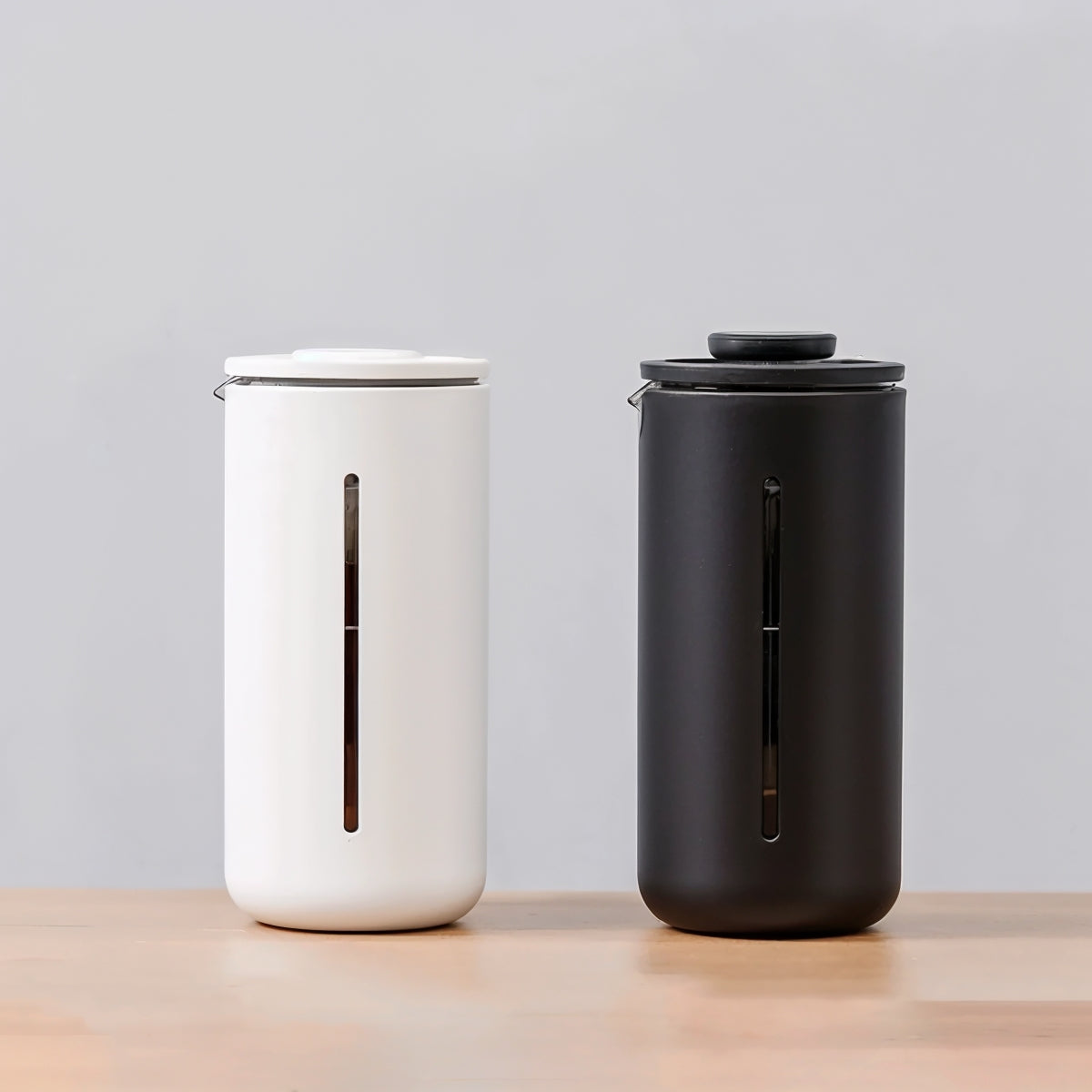 Front shot of two Timemore U French press's with a soft colour background studio shot