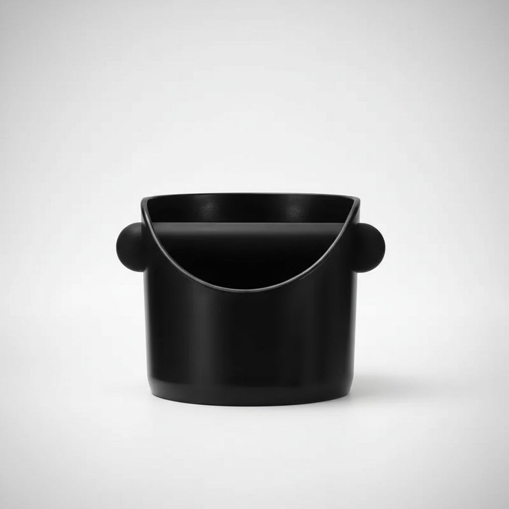 Black cylindrical coffee grounds knock box with spherical ends on a white background