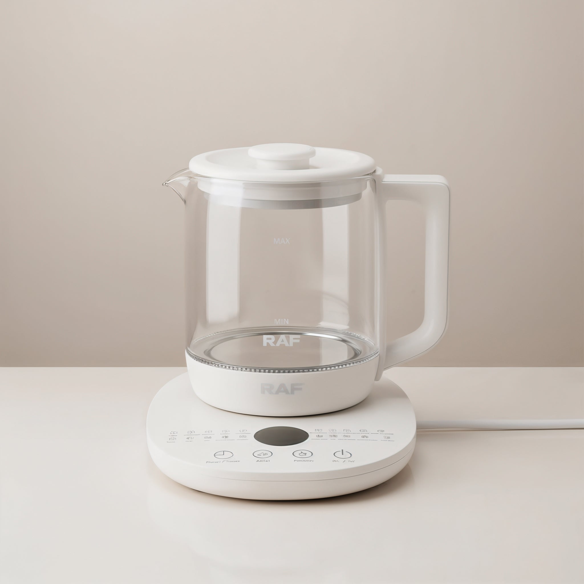 Front view of a RAF 1.5 White electric kettle with clear glass carafe on a beige surface 